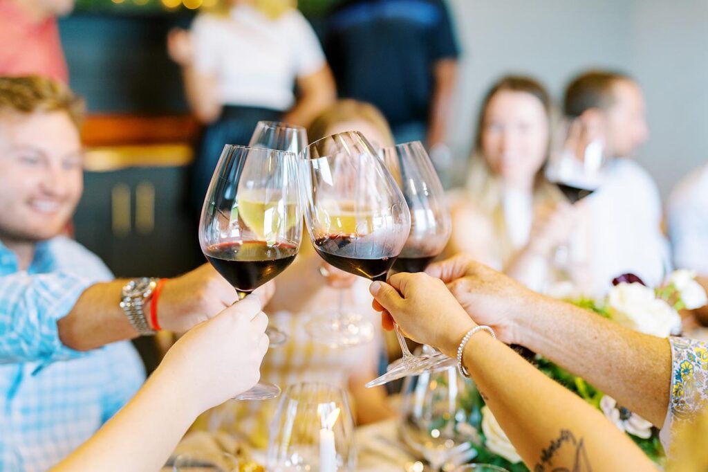 Guests raising glasses of wine together during a guided private tasting at Dynamis Estate Wines